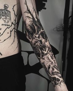 two people with tattoos on their arms, one has a skull and the other has a skeleton