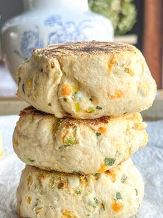 three biscuits stacked on top of each other in front of a blue and white vase