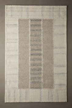 a beige and grey rug with vertical stripes