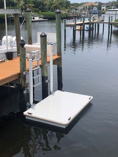 there is a dock that has some chairs on it in the middle of the water