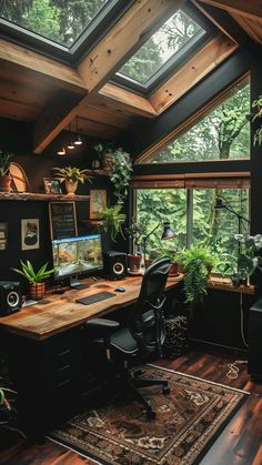 a home office with lots of windows and plants on the desk in front of it