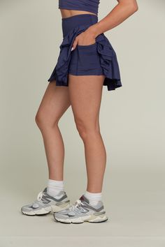 Our 15" True Navy Pleated Tennis Skirt is our famous pleated tennis skirt, now in a longer length of 15". The skirt features built-in spandex shorts that include a comfortable fit and side pockets for storage. This exclusively designed Gold Hinge skirt is made of quick dry material and can take on any activity such as golf, tennis, running and more. Gold Hinge Tennis Skirt, Elastane Tennis Skirt With Built-in Shorts And 4-way Stretch, Moisture-wicking Short Tennis Skirt With 4-way Stretch, Blue Stretch Tennis Skirt With Built-in Shorts, Blue Moisture-wicking Tennis Skirt For Sports, Pleated Tennis Skirt, Spandex Shorts, Vintage Havana, Favorite Daughter