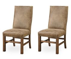 a pair of brown chairs sitting next to each other