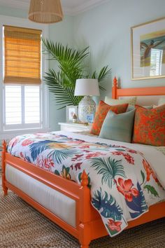 a bedroom with an orange bed and palm trees in the window sill above it