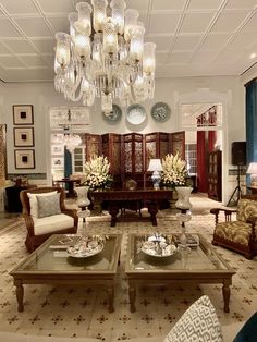 a living room filled with furniture and a chandelier