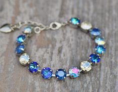 A gorgeous new bracelet made with Swarovski crystal. The bracelet features 8mm crystals ranging in color from royal blue de lite, royal blue, aqua transmission, crystal moonlight, and bermuda blue color. Crystals are hand set into a premium bracelet setting, and prong set. Bracelet will adjust to fit wrist sizes 6 inches and up. Please choose desired metal finish at checkout. Shown in silver in images above. ** Nickel and lead free Blue Crystal Bracelet, Set Bracelet, Stacked Necklaces, Crystal Bracelet, Tennis Bracelet, Blue Crystals, Chain Link Bracelet, Crystal Bracelets, Bracelet Making