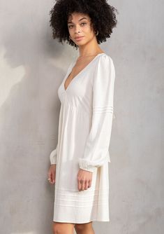 Designed in a lightweight linen blend, this retro-inspired mini dress is an instant bohemian classic. Featuring long voluminous sleeves, an adjustable tie-back detail, and delicate pintuck details. An effortless style that pairs well with a simple leather sandal. Linen blend Relaxed fit Long voluminous sleeve Elastic wrist cuff Mini length V-neckline Adjustable tie-back detail Half elastic waist at the back Empire waist Pintuck details Classic bohemian mini dress Model is 5'9, wearing a size S.S Feminine Pleated Sleeve Mini Dress For Brunch, Spring Daywear Puff Sleeve Dress With Bishop Sleeves, Spring Puff Sleeve Dress With Bishop Sleeves For Daywear, Chic Mini Dress With Smocked Back And Balloon Sleeves, Feminine Mini Dress With Gathered Sleeves For Brunch, Feminine Mini Dress With Elastic Sleeves For Brunch, Spring V-neck Mini Dress With Blouson Sleeves, Spring Billowy Puff Sleeve Dress With Pleated Sleeves, Spring Puff Sleeve Dress With Pleated Billowy Sleeves