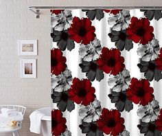 a red and black flower shower curtain hanging on a bathroom wall next to a white chair