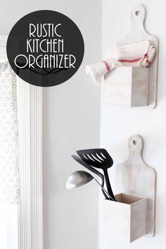 two kitchen utensils are hanging on the wall next to a spoon and spatula holder