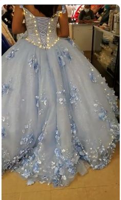 Make your quinceanera celebration magical with this Sky Blue 3D Applique Off-Shoulder Ball Gown Quinceanera Dress. The classic ball gown is crafted from delicate tulle, creating a voluminous and graceful look fit for a princess. The off-the-shoulder neckline enhances the romantic allure, framing your shoulders beautifully. The intricate 3D appliques adorn the gown, adding texture and artistry to its ethereal design. The corset back ensures a flawless fit, giving you both support and style as you Sky Blue Long Dress, Light Blue Long Dress, Winter Wonderland Dress, Light Blue Quinceanera Dresses, Gown Sleeves, Cinderella Quinceanera, Ball Gown Quinceanera Dresses, Xv Dresses, Blue Long Dress