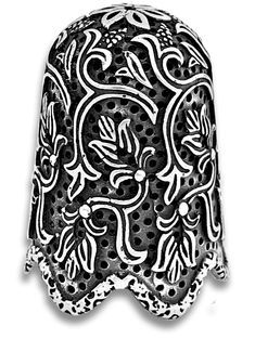 an ornate black and white object with dots