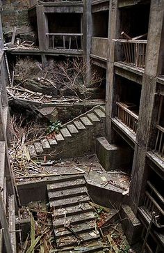 an abandoned building with stairs leading up to the second floor