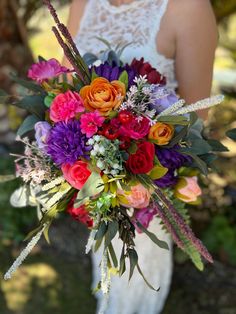 a woman holding a bouquet of flowers in her hands