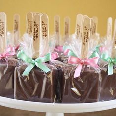 chocolate candies wrapped in cellophane and tied with bows on a cake plate