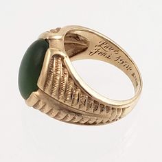 "This striking 14K gold ring features a large green jade stone and an engraved band that resembles a stylized fern or feather. Just the right combination of style and masculinity! Note that the inside of this ring has a lovers inscription and date 1974. Style: Classic, Masculine Vintage: 1970s Materials: 14K Gold, Green Jade Size: 10 Green Jade: 16mm x 12mm Width North to South: approx. 3/4\" Weight: 7.5 dwt / 11.6 g Condition: Very Good ASK ABOUT OUR FREE LAYAWAY! FREE FULLY INSURED PRIORITY SH Heirloom Style Green Emerald Ring With Polished Finish, Antique Green Emerald Ring With Polished Finish, Heirloom Green 14k Gold Signet Ring, Antique Green Rings With Polished Finish, Vintage Green Signet Ring With Polished Finish, Green Carved Rings For Formal Occasions, Green 14k Gold Signet Ring, Vintage Green 14k Gold Signet Ring, Heirloom Green Signet Ring For Formal Occasions