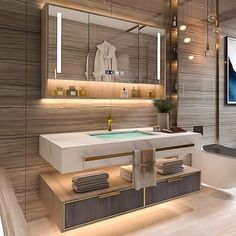 a bathroom with a sink, mirror and bathtub in the middle is illuminated by recessed lights