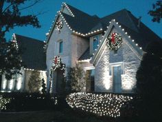 a large house with christmas lights on it's windows