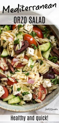 a bowl full of pasta salad with tomatoes and cucumbers