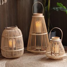 three wicker lanterns sitting on top of a rug