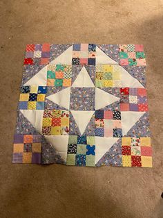 a patchwork quilt is laying on the floor