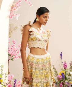 Editor's Note Featuring an ivory chanderi multicolour beadwork ruffled bustier Note: Lehenga worn by model is for styling purposes and can be purchased separately. Color: Ivory Fabric: Chanderi Component: Bustier Occasion: Festive and Wedding Guest Care: Dry Clean Only About the Designer Chandrima celebrates diversity in cultures and craft forms creating ready-to-wear women wear for the urban woman of today. The brand embodies the idea of Indian handloom and craft merged with an international st Luxury Chanderi Tops For Festivals, Bohemian Summer Lehenga With Floral Embroidery, Summer Multicolor Choli With Floral Embroidery, Summer Beige Sets With Intricate Embroidery, Multicolor Fitted Choli For Summer, Fitted Multicolor Choli For Summer, Summer Floral Embroidery Multicolor Choli, Bohemian Resham Embroidery Choli For Summer, Multicolor Floral Embroidery Lehenga For Summer