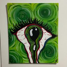 a painting with green and white swirls in the shape of an eye on it