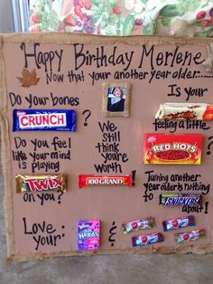 a sign with candy and candies on it that says happy birthday merhene now that your another year older