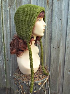 "Style: Chunky bonnet with I-cord ties. Color: This hat is shown in Cilantro, an olive green. Sizes: One size fits average teen or adult head size of 20\" to 23\" (50.5 cm to 58 cm). Fiber Content: 80% acrylic, 20% Wool Characteristics: Whimsical, chunky, very soft, warm and cozy. Care Instructions: Hand wash, dry flat. Every item from Pixiebell is handmade and knit or crocheted to order, unless otherwise stated in title of the item as \"ready to ship\". Production time may vary, please check th Olive Hat, Aviator Cap, Knit Bonnet, Hood Hat, Hats Winter, Womens Hats, Chunky Knit Hat, Aviator Hat, Pixie Hat