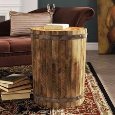 a wooden barrel table sitting on top of a rug