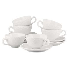 four white cups and saucers on a plate