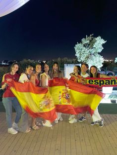 a group of young women holding spanish flags