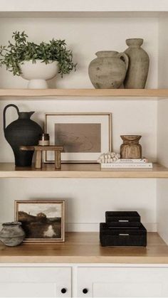 some shelves with vases and pictures on them