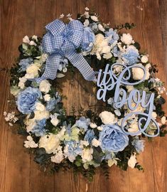 a blue and white wreath with the word joy spelled in cursive letters on it