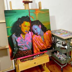 two paintings on easels in an art studio