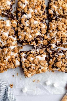 homemade granola bars with chocolate and marshmallows on top, ready to be eaten