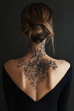 the back of a woman's neck with flowers on it