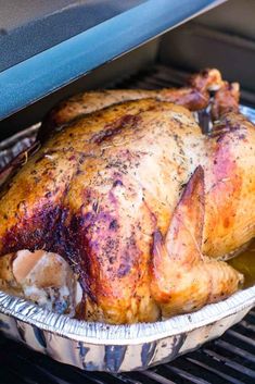 a roasted turkey sitting in an oven with the words smoked turkey on it's side