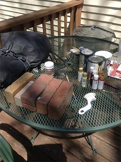 an outdoor table with various items on it