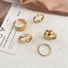 Add some bling to your fingers with this set of five stackable goldtone rings. Designs from openwork double bands to braided texturing keep your options open. Includes five goldtone rings Ring 1 and 2: 0.35'' W Ring 3: 0.31'' W Ring 4 and 5: 0.47'' W Goldtone copper Gothic Style Fashion, Makeup Hairband, Moon And Star Ring, Vintage Headbands, American Wedding, Geometric Ring, Gold Ring Sets, Vintage Punk, 5 Rings