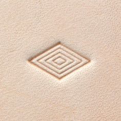 a square shaped object is shown in the sand