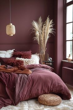 a bedroom with purple walls and white furnishing on the floor, along with a large bed