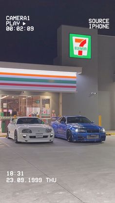 two cars parked in front of a gas station