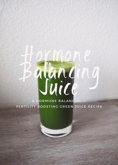 a green smoothie in a tall glass with the words homemade balancing juice on it