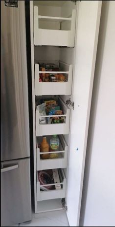 the refrigerator door is open and it's full of different items in its drawer