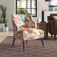 a living room with two chairs and a rug on the floor in front of a window