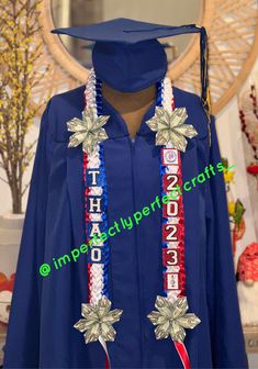 a blue graduation gown with silver stars and ribbons