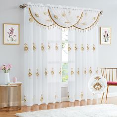 a living room with white and gold curtains