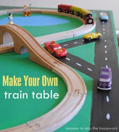 a toy train set with cars and trucks on the tracks that make your own train table