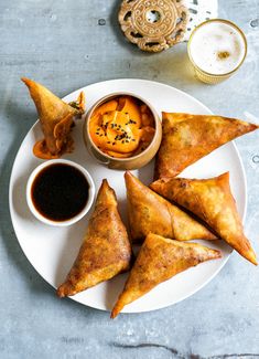 some food is sitting on a plate with dipping sauce