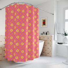 a pink shower curtain with yellow flowers on it in a white bathtub next to a window